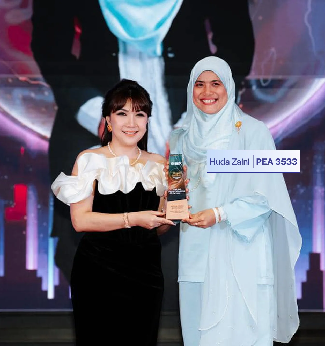 Huda receiving an award for her real estate performance
